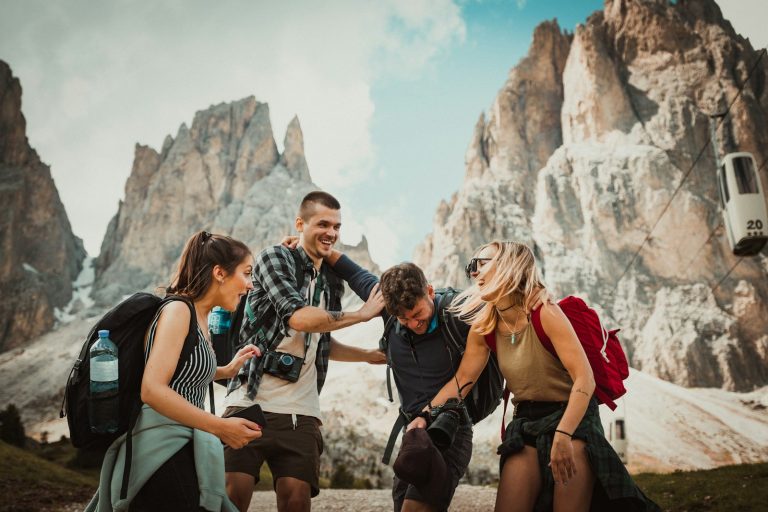 Group of friends laughing together on a mountain trip